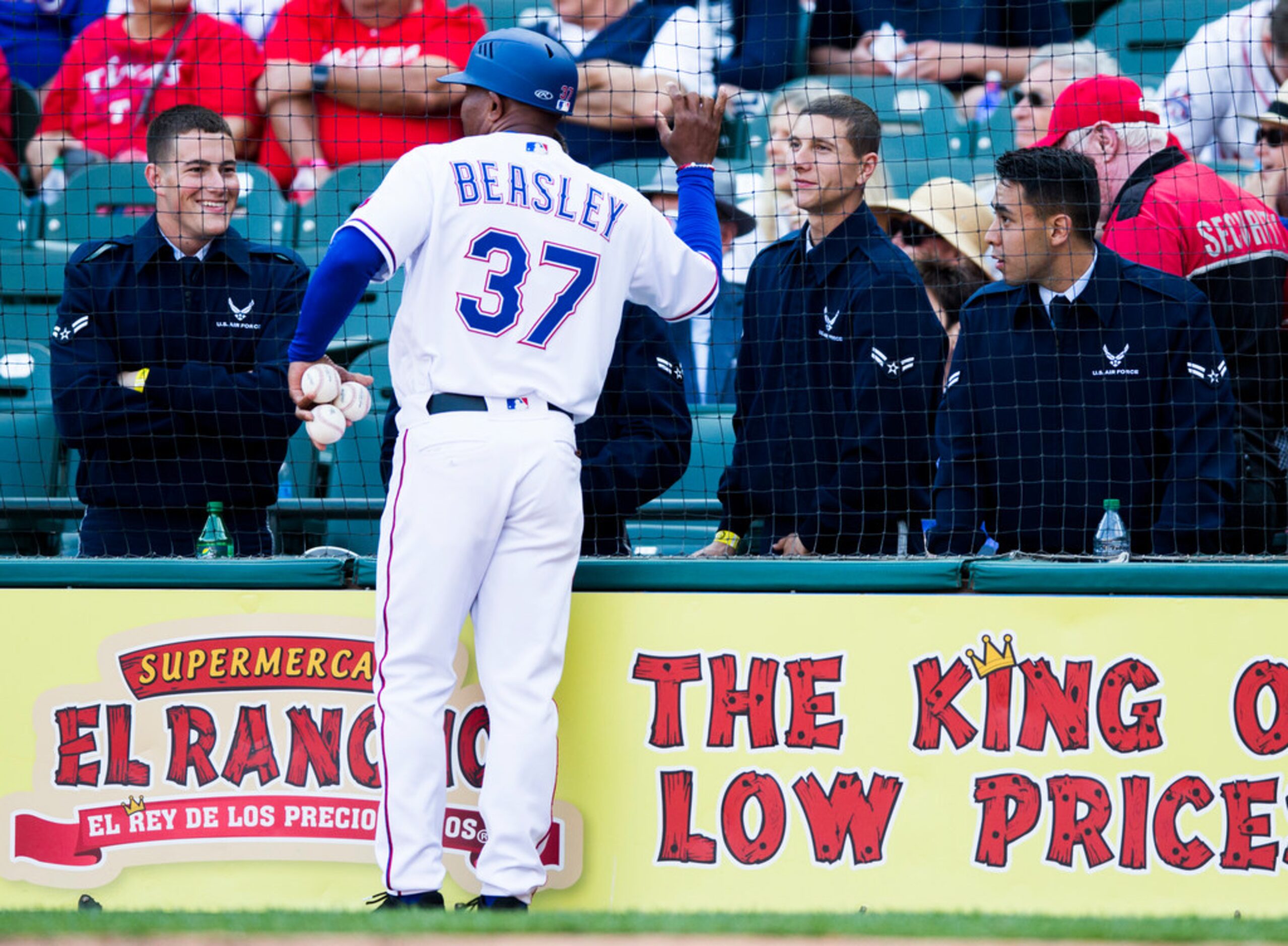 Texas Rangers third base coach Tony Beasley (37) talks to Navy servicemen during the ninth...