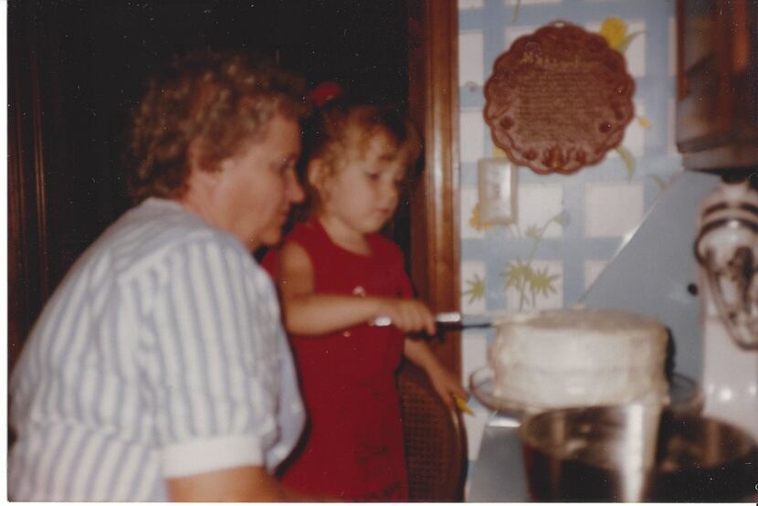 Nancy McCall, Nanette Light's grandmother, watches as Light ices her fourth birthday cake in...