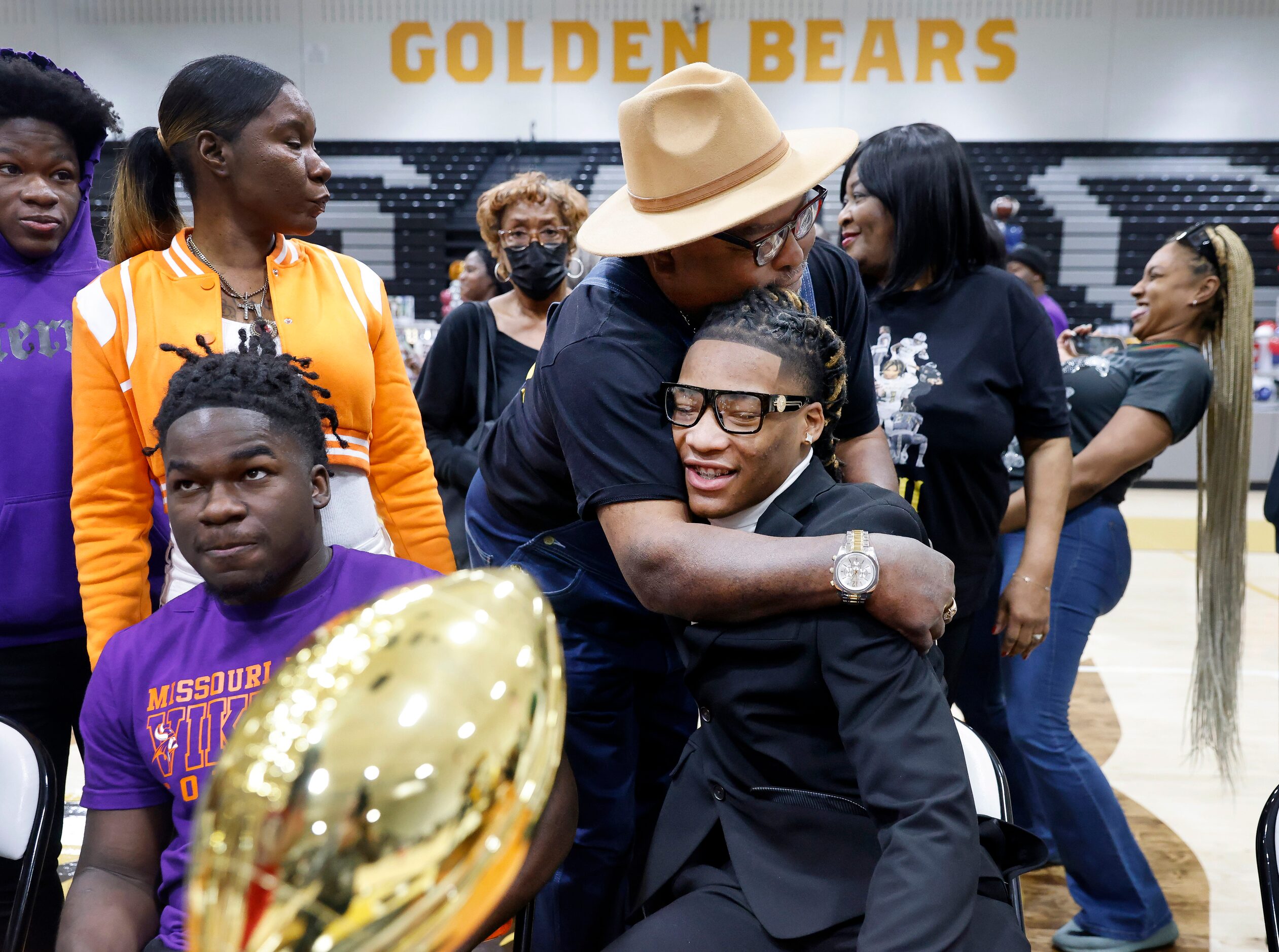 South Oak Cliff football player Danny Green Jr  (with glasses) receives a hug from his...