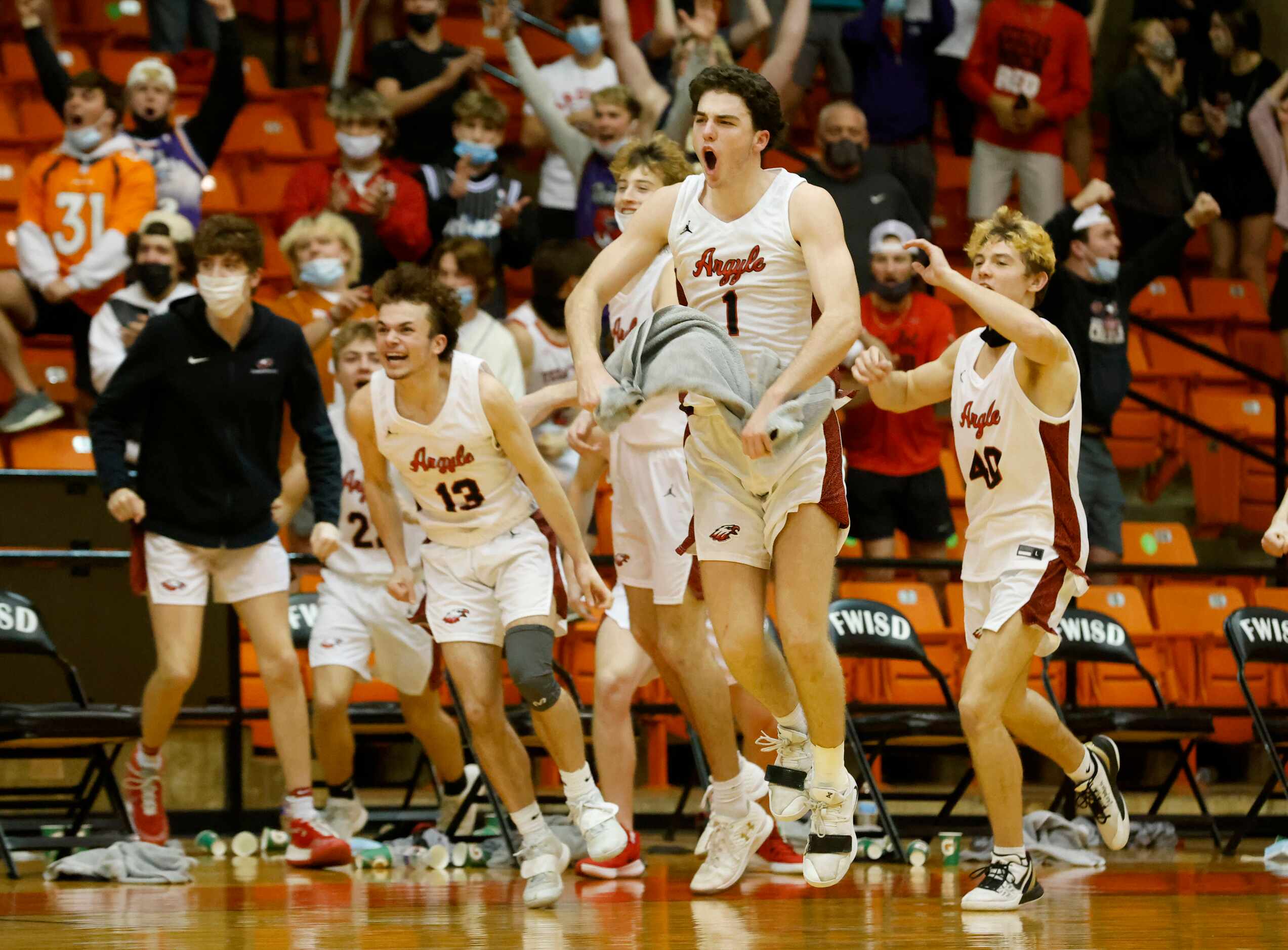 Argyle’s Blake Petter (13) Jacob Dye (1) and Rand Nash (40) celebrate their victory over Oak...