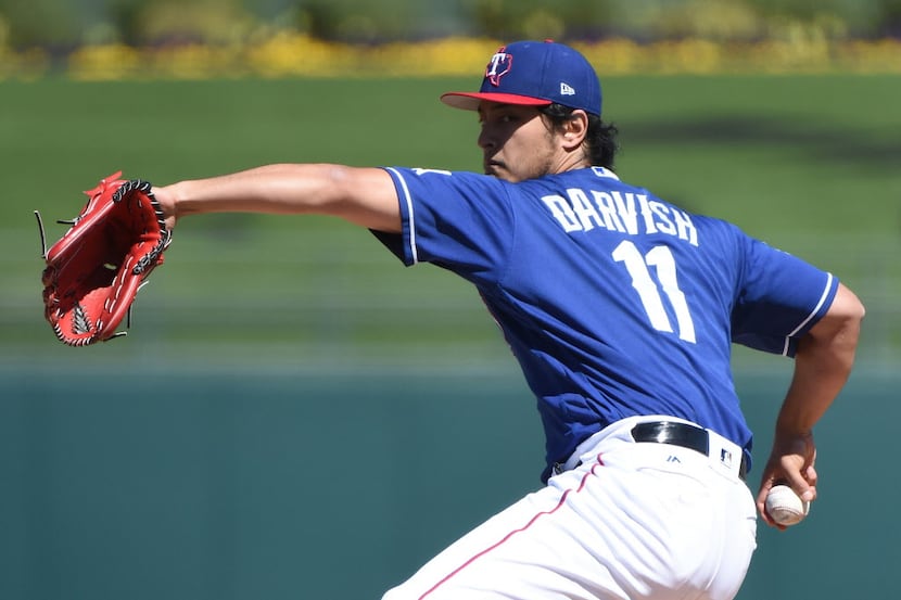 SURPRISE, AZ - MARCH 07:  Yu Darvish #11 of the Texas Rangers pitches in the first inning of...