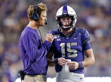 TCU Co-Offensive Coordinator Sonny Cumbie (left) confers with TCU Horned Frogs quarterback...