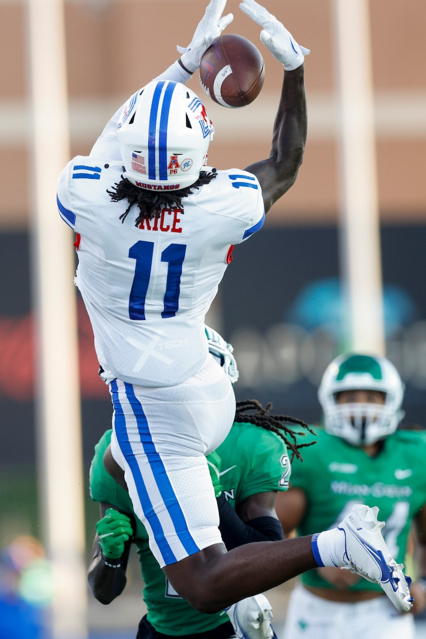 SMU wide receiver Rashee Rice (11) catches a pass over UNT defensive back DeShawn Gaddie (2)...