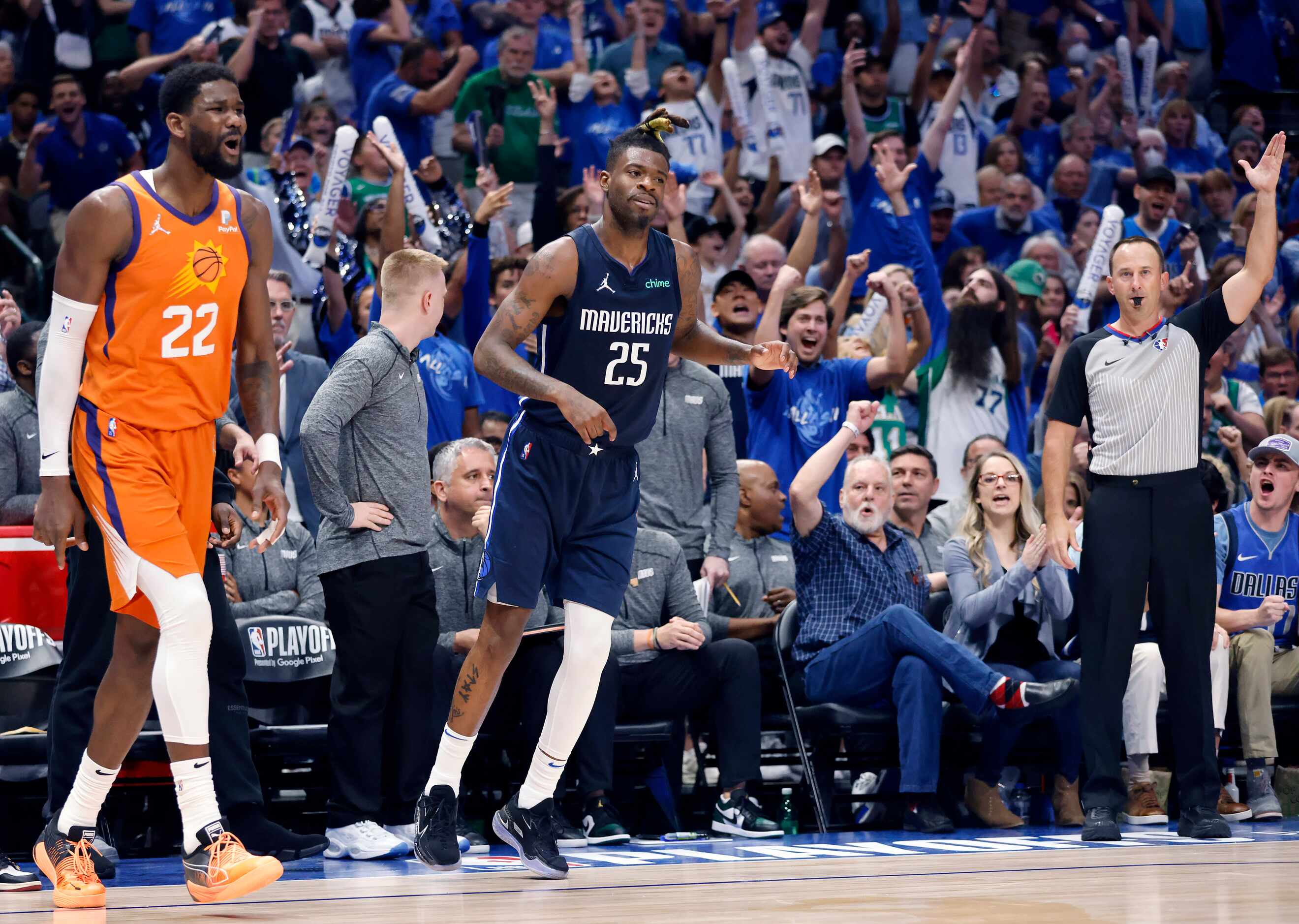 Dallas Mavericks fans celebrate after Dallas Mavericks forward Reggie Bullock (25) hit a...