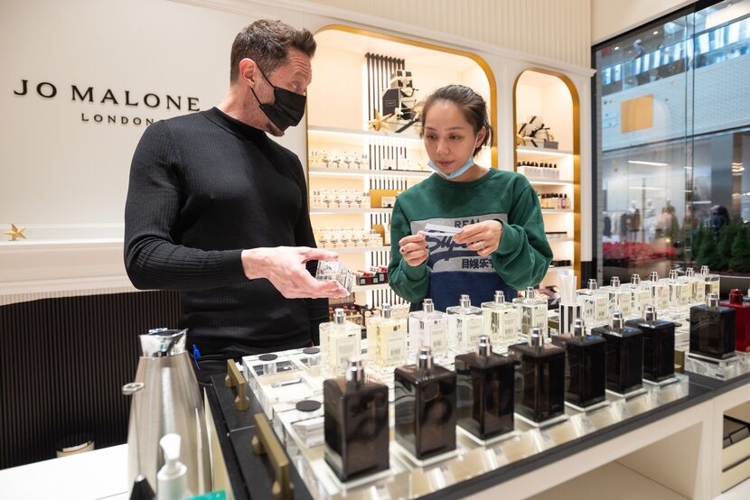 Employee Chad Spurrier, left, works with shopper Jessica Pham as she conducted her Black...