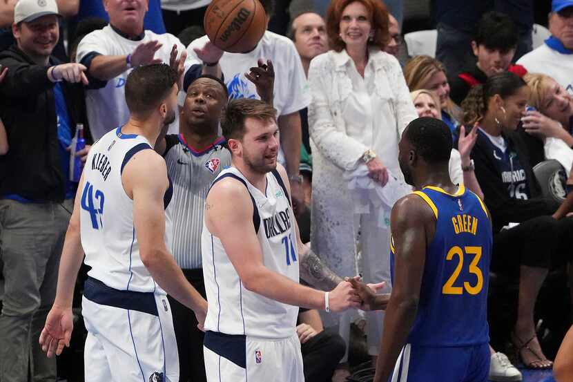 Dallas Mavericks guard Luka Doncic (77) shakes hands with Golden State Warriors forward...