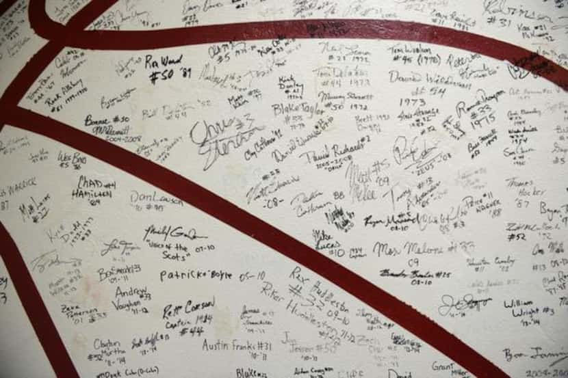 The Highland Park boys basketball locker room features a wall of signatures of past players. 