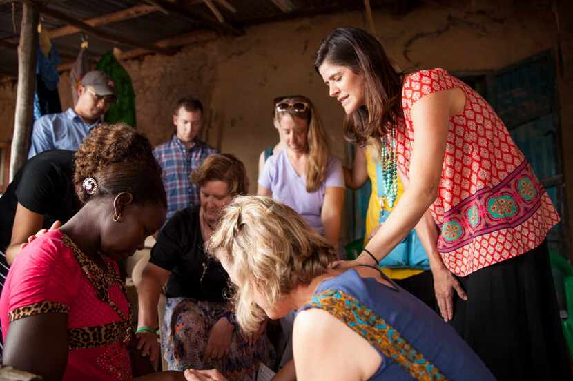 
Missy Williams (far right) and other American volunteers of Seed Effect pray with Annet...