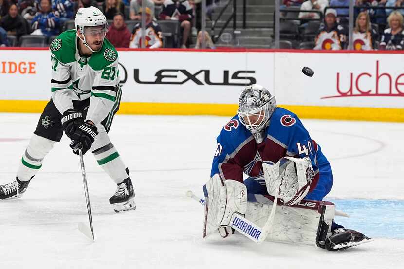 Colorado Avalanche goaltender Alexandar Georgiev, right, deflects a shot by Dallas Stars...