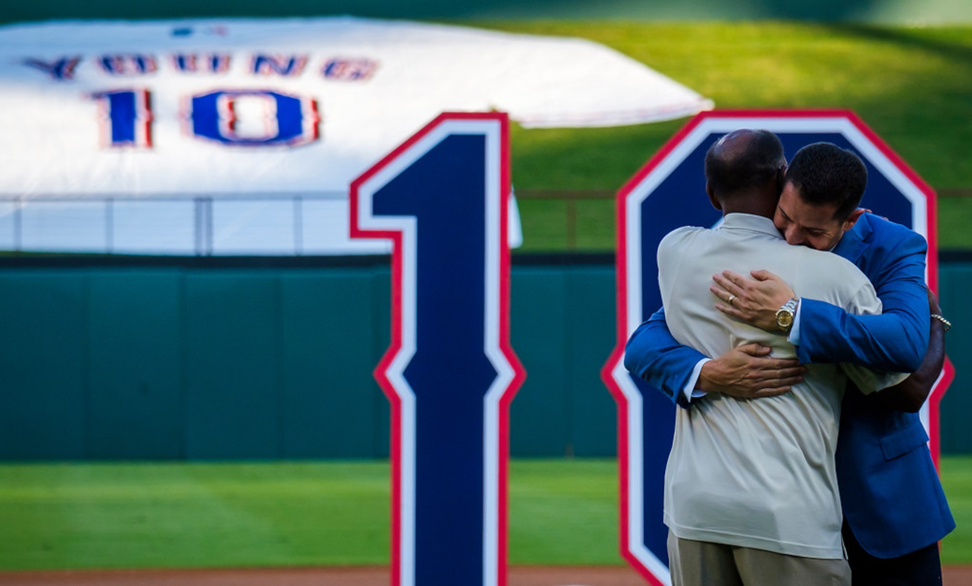 Michael Young hugs former Texas Rangers manager Ron Washingtong during ceremonies to retire...