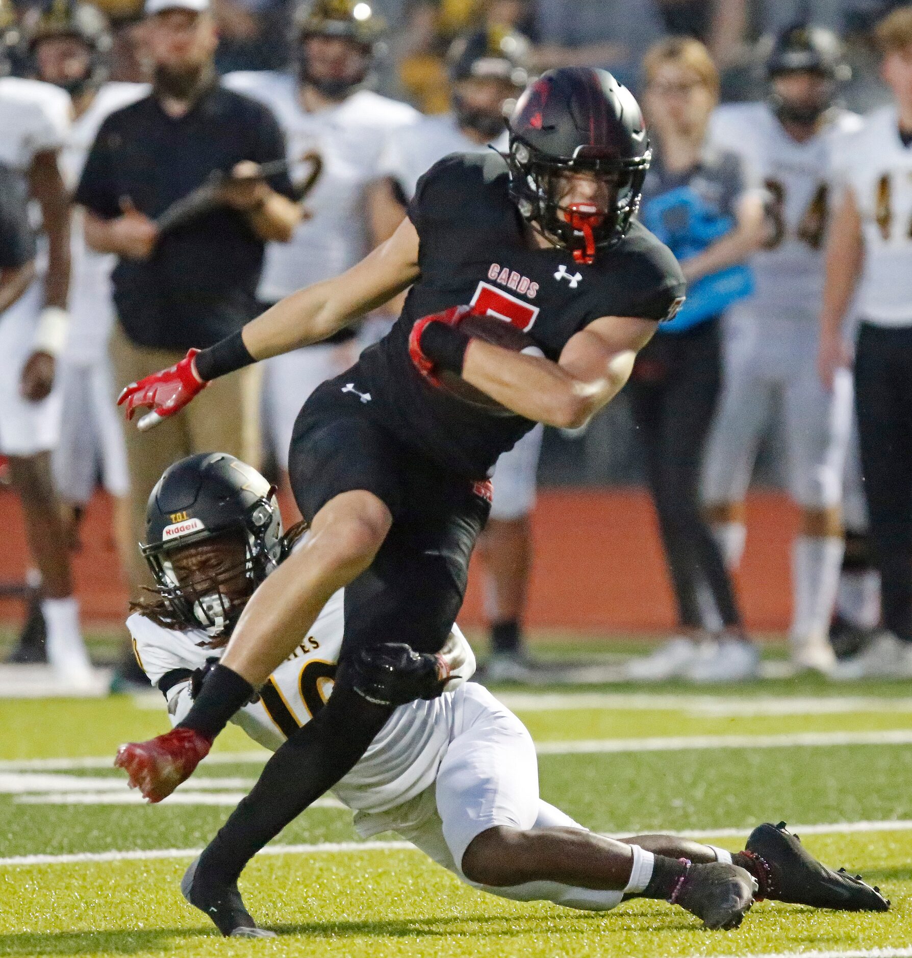 Melissa High School tight end Gunnar Wilson (7) breaks through the tackle attempt by...