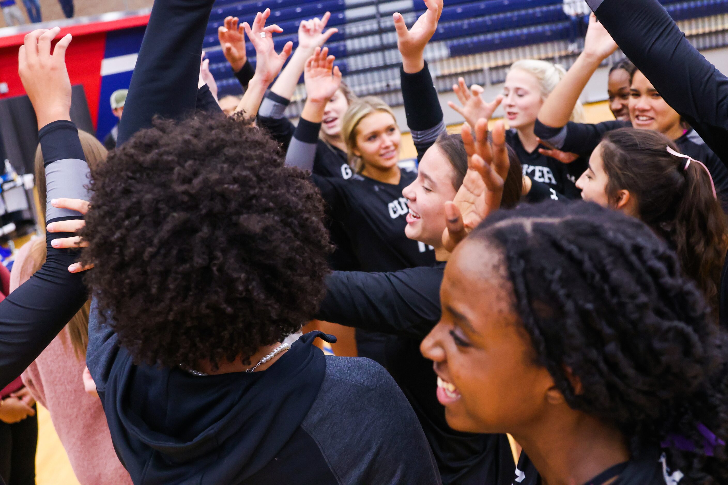 Denton Guyer players break from a winner's huddle after beating Allen in a five-set game in...