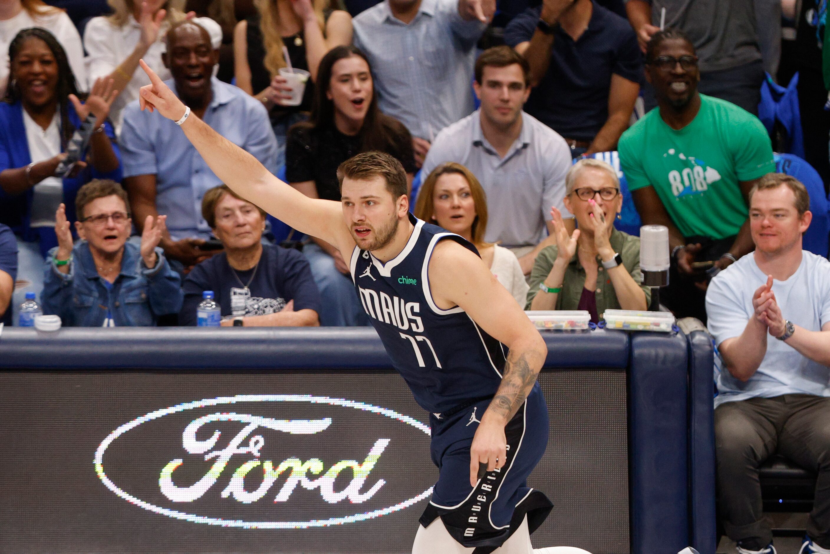 Dallas Mavericks guard Luka Doncic (77) celebrates after making a three-point shot during...