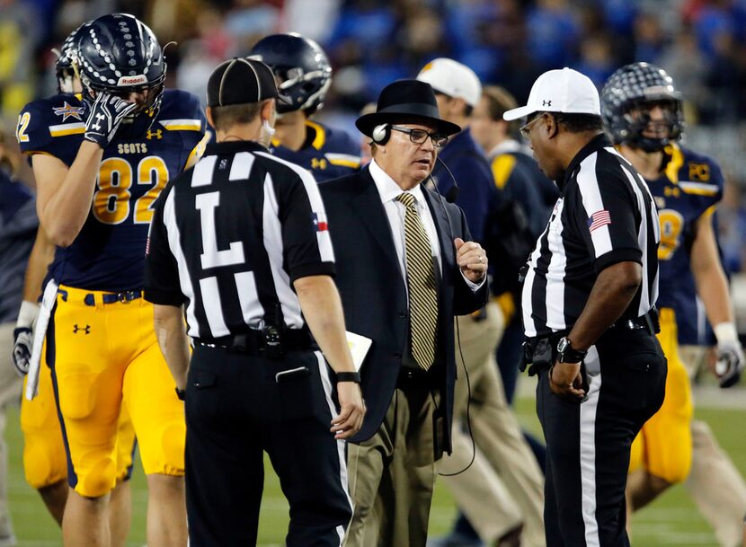 Highland Park coach Randy Allen talks with officials, after a player was injured,  during...