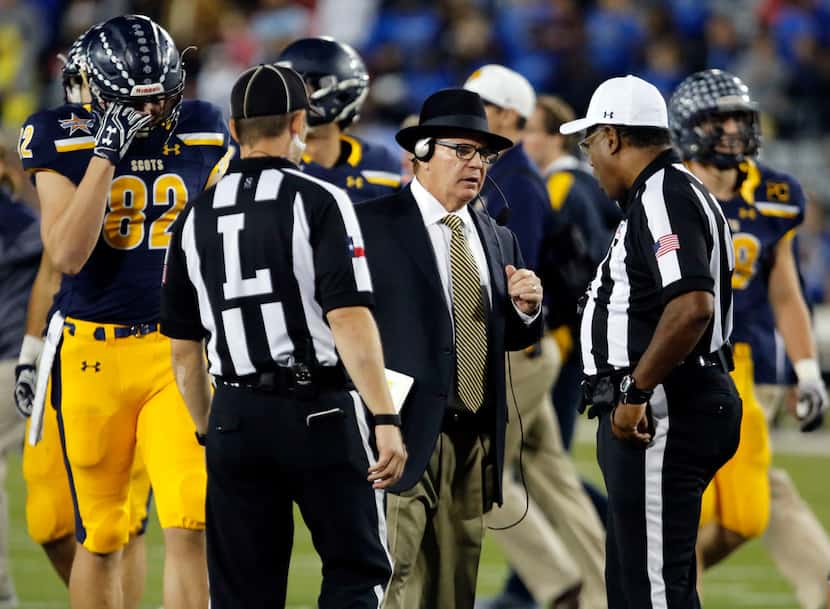 Highland Park coach Randy Allen talks with officials, after a player was injured,  during...