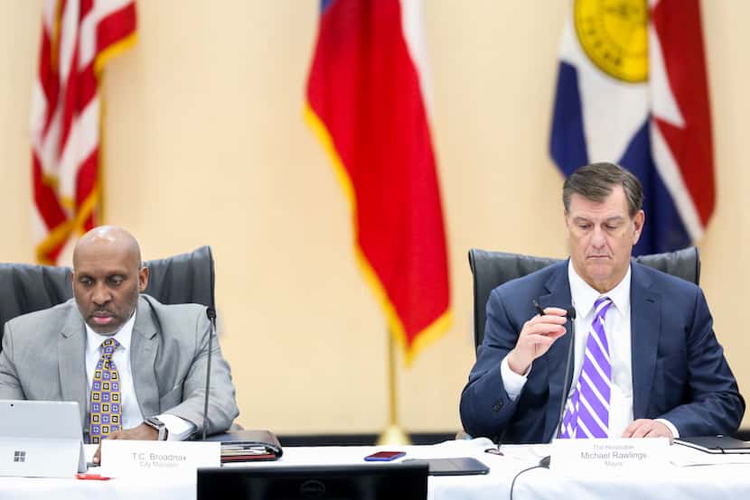 Dallas City Manager T.C. Broadnax, left, listens along with  Mayor Mike Rawlings, right,...
