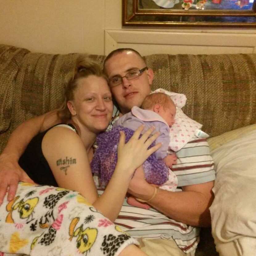 Alishia Haney (left) and Sam Smith with one of their children. 