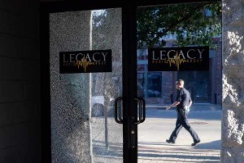  A bullet shattered the glass door at the Legacy Studios. (David Woo/Staff Photographer)