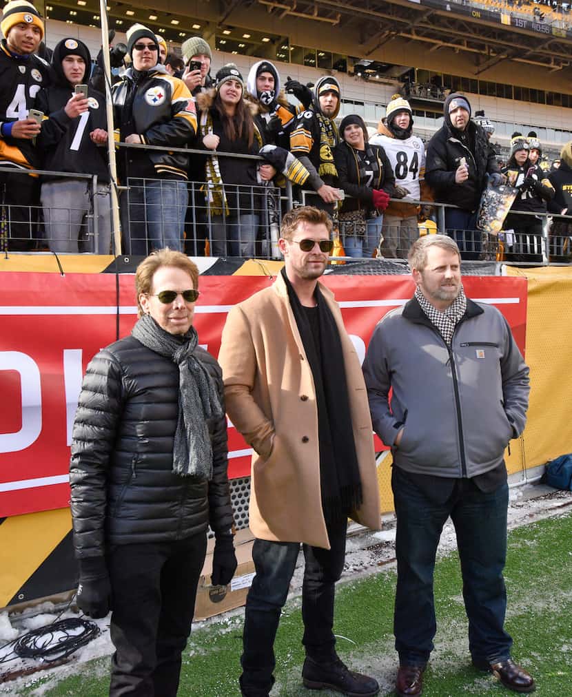 Actor Chris Hemsworth (center) stands on the sidelines with Mark Nutsch (right) the soldier...