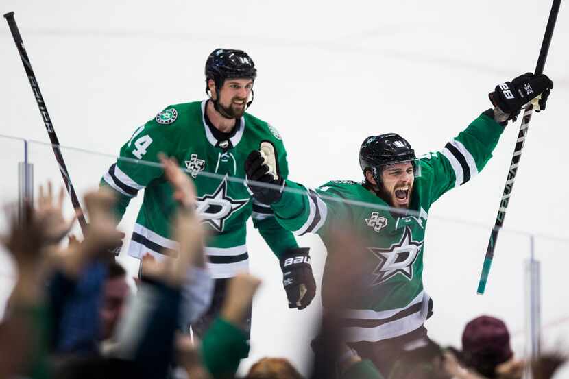 Dallas Stars center Tyler Seguin (91) and left wing Jamie Benn (14) celebrate a goal that...