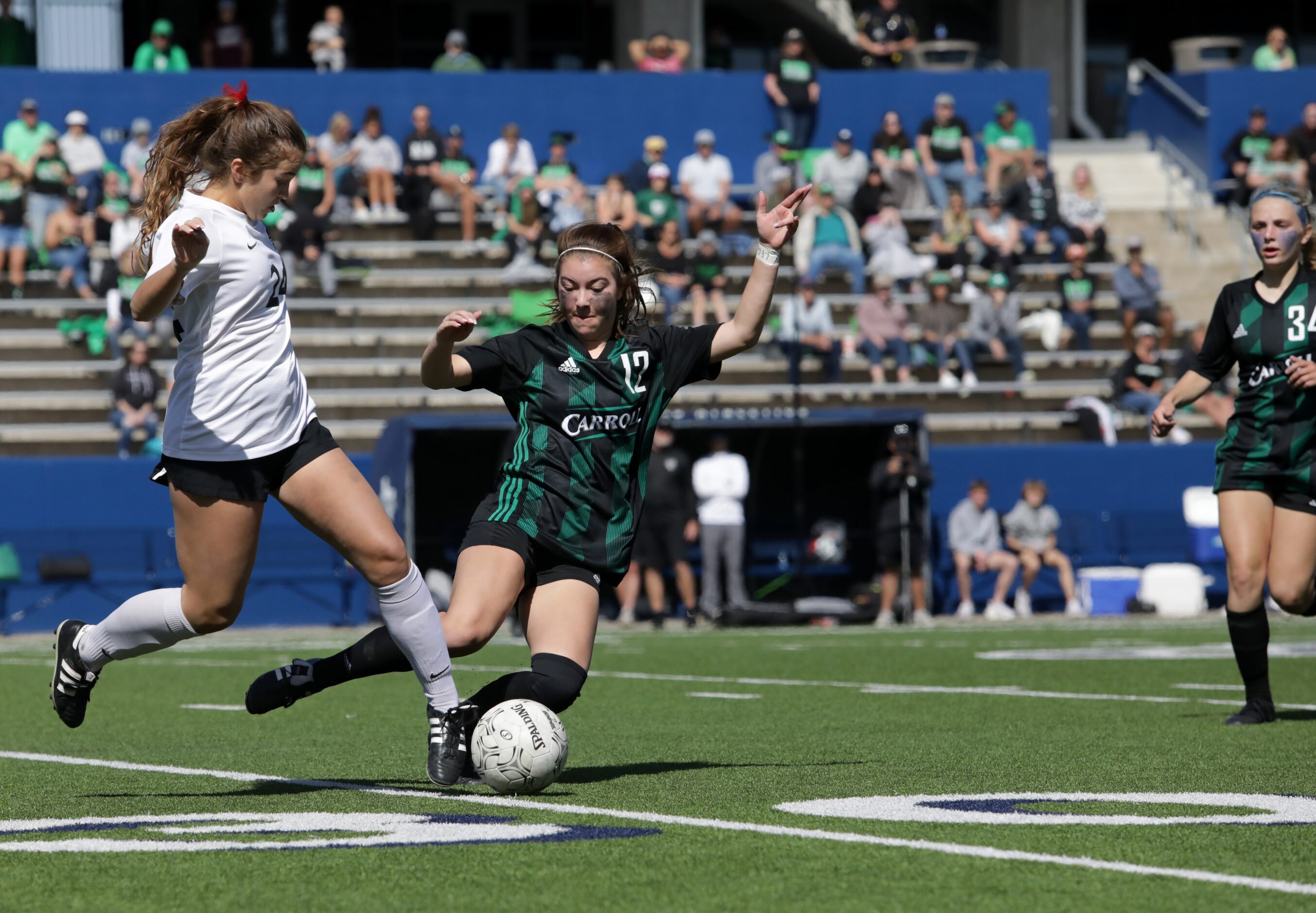 Mound Marcus player #24, Lyndi Maxson, goes up against Southlake Carroll Flower player #12,...