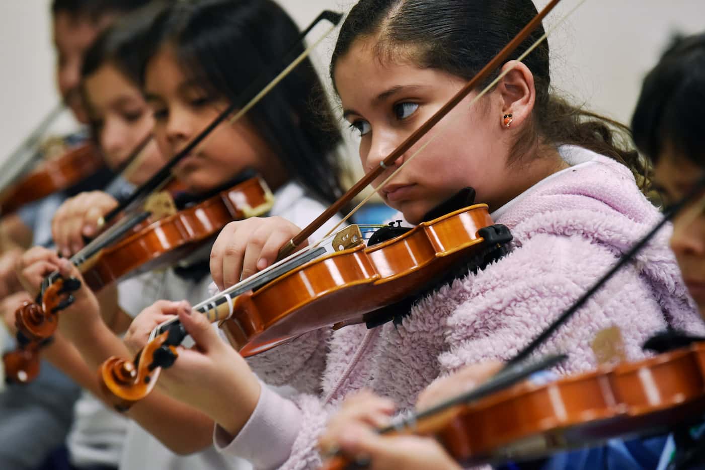 Bella Lupian, right, plays her violin with a group of fourth graders during an afterschool...
