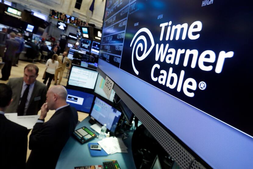 In this Tuesday, May 17, 2016, photo, the Time Warner Cable logo appears above the post...