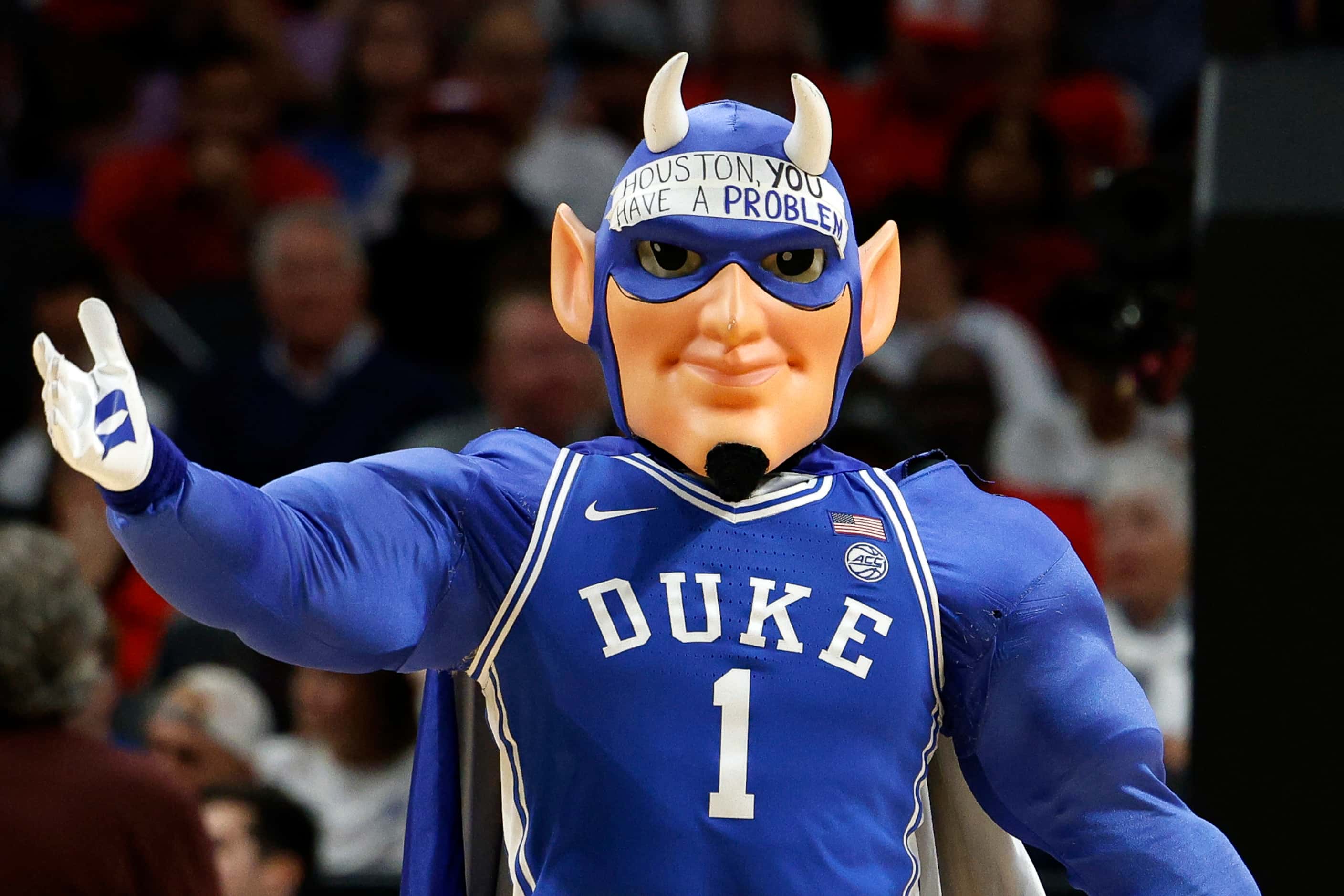 The Duke Blue Devil wears a piece of tape with “Houston, you have a problem” on its forehead...