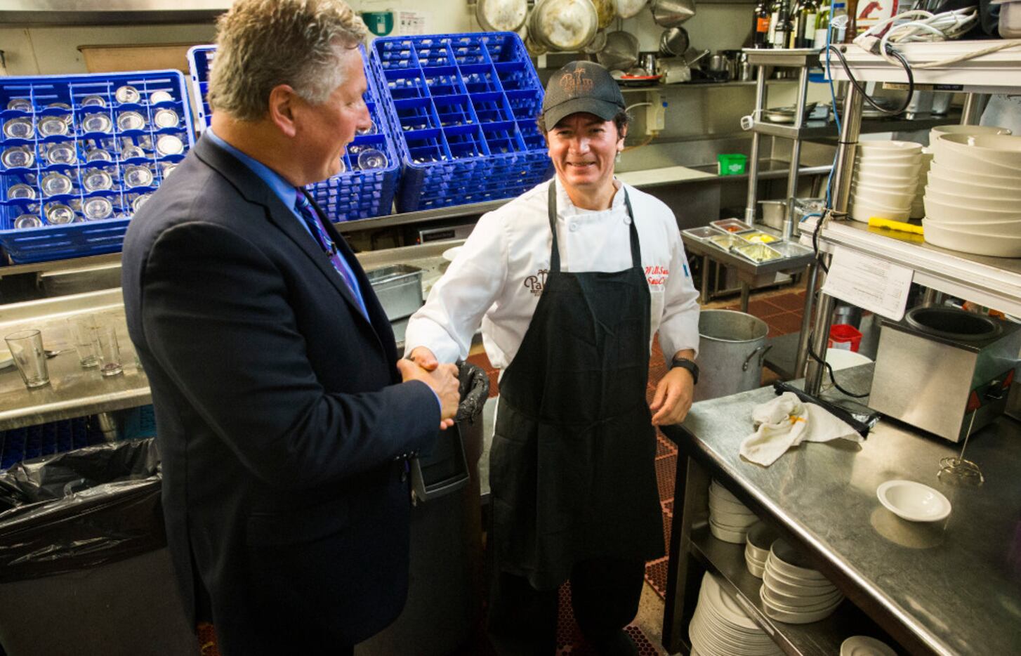 Al Biernat, former manager of the Palm restaurant, shakes hands with long-time sous chef...