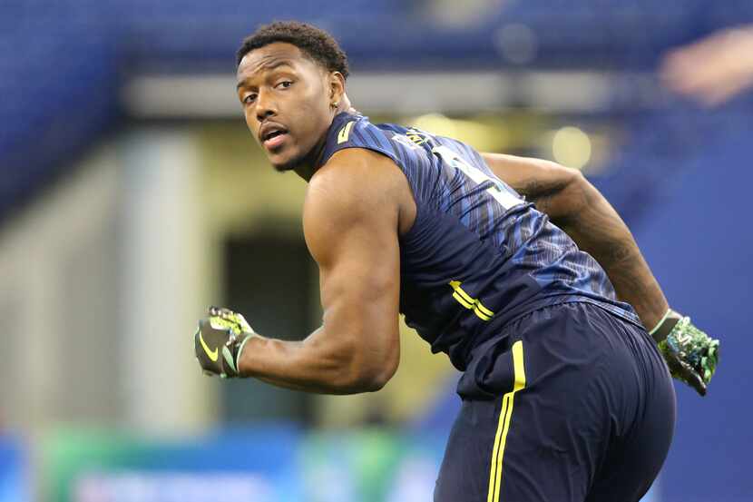 Michigan defensive end Taco Charlton competes in a drill at the 2017 NFL football scouting...