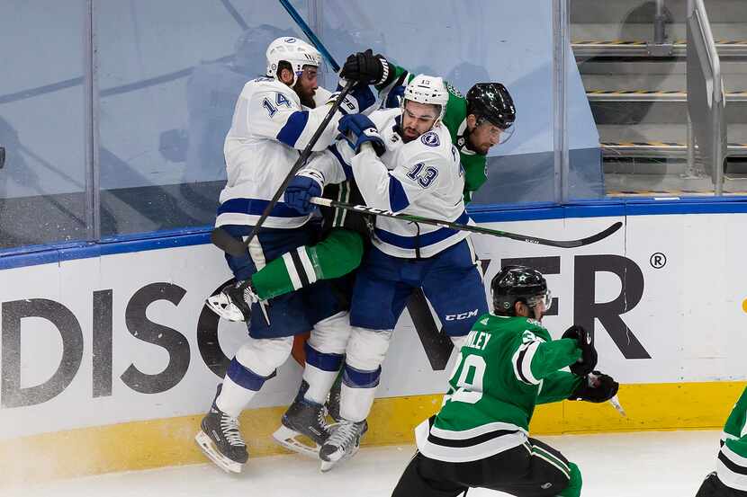 Andrej Sekera (5) of the Dallas Stars is sandwiched by Pat Maroon (14) and Cedric Paquette...