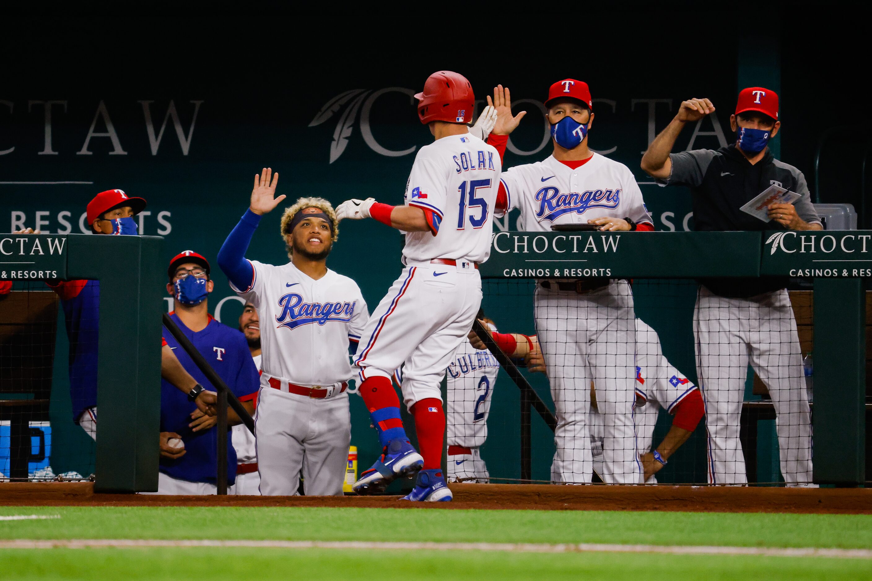 Texas Rangers second baseman Nick Solak (15) runs to the dugout after hitting a homer on a...