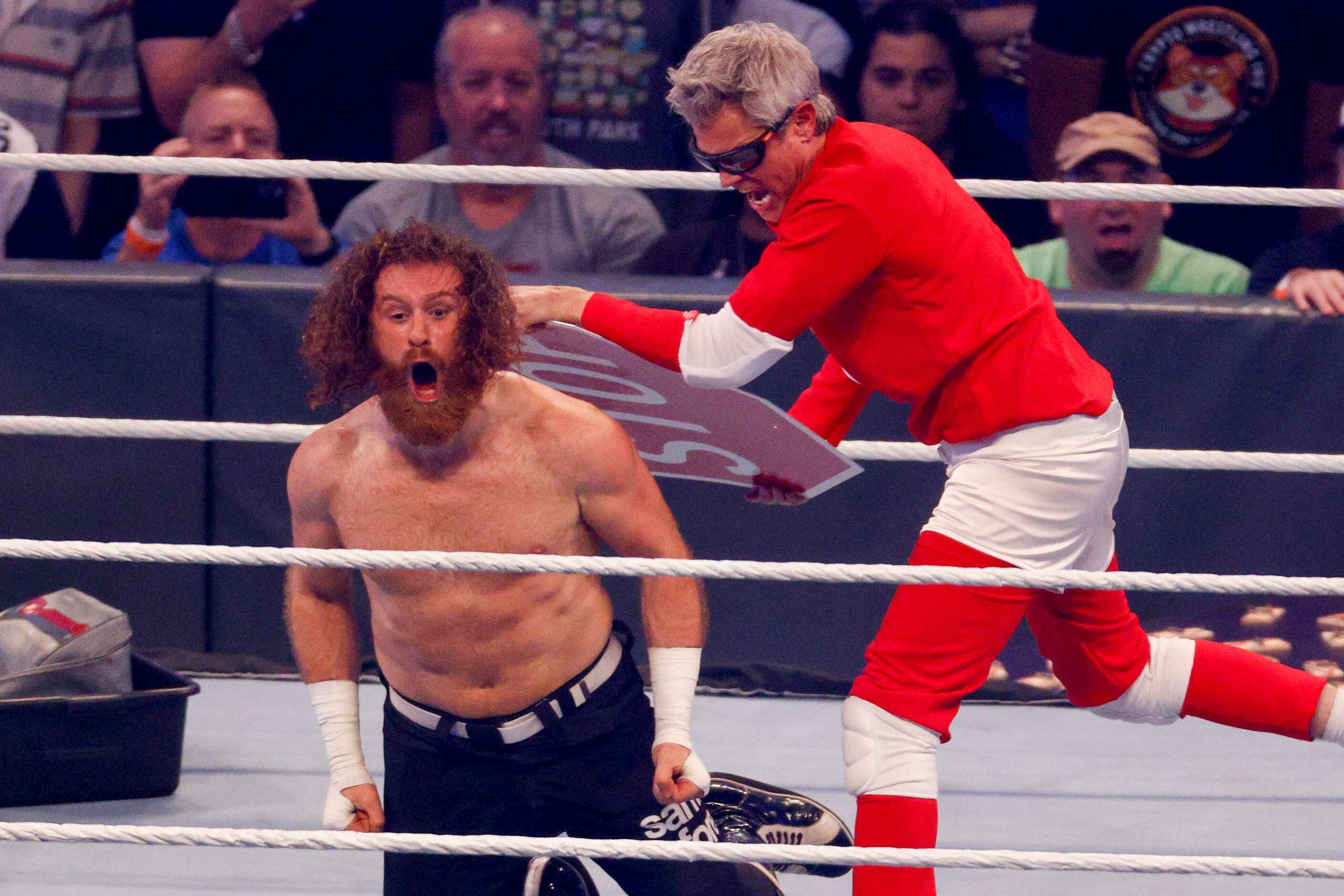 Johnny Knoxville (right) hits Sami Zayn with a stop sign during a match at WrestleMania...