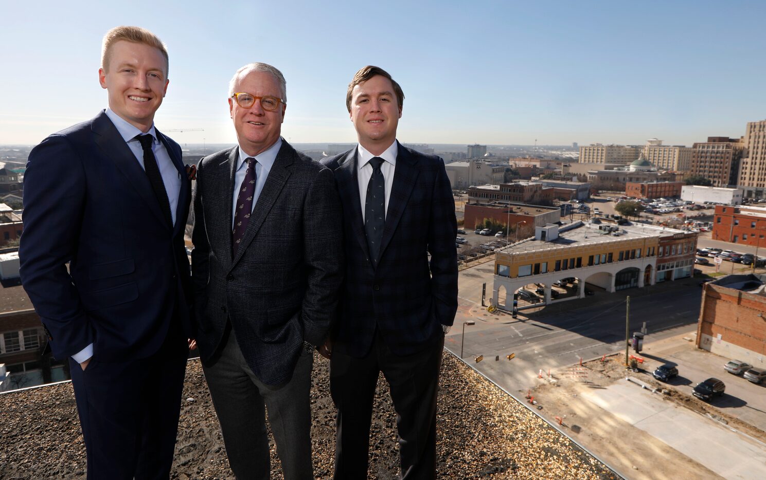 Shawn Todd, founder and CEO of Todd Interests, center, with his sons, Patrick, left, and...