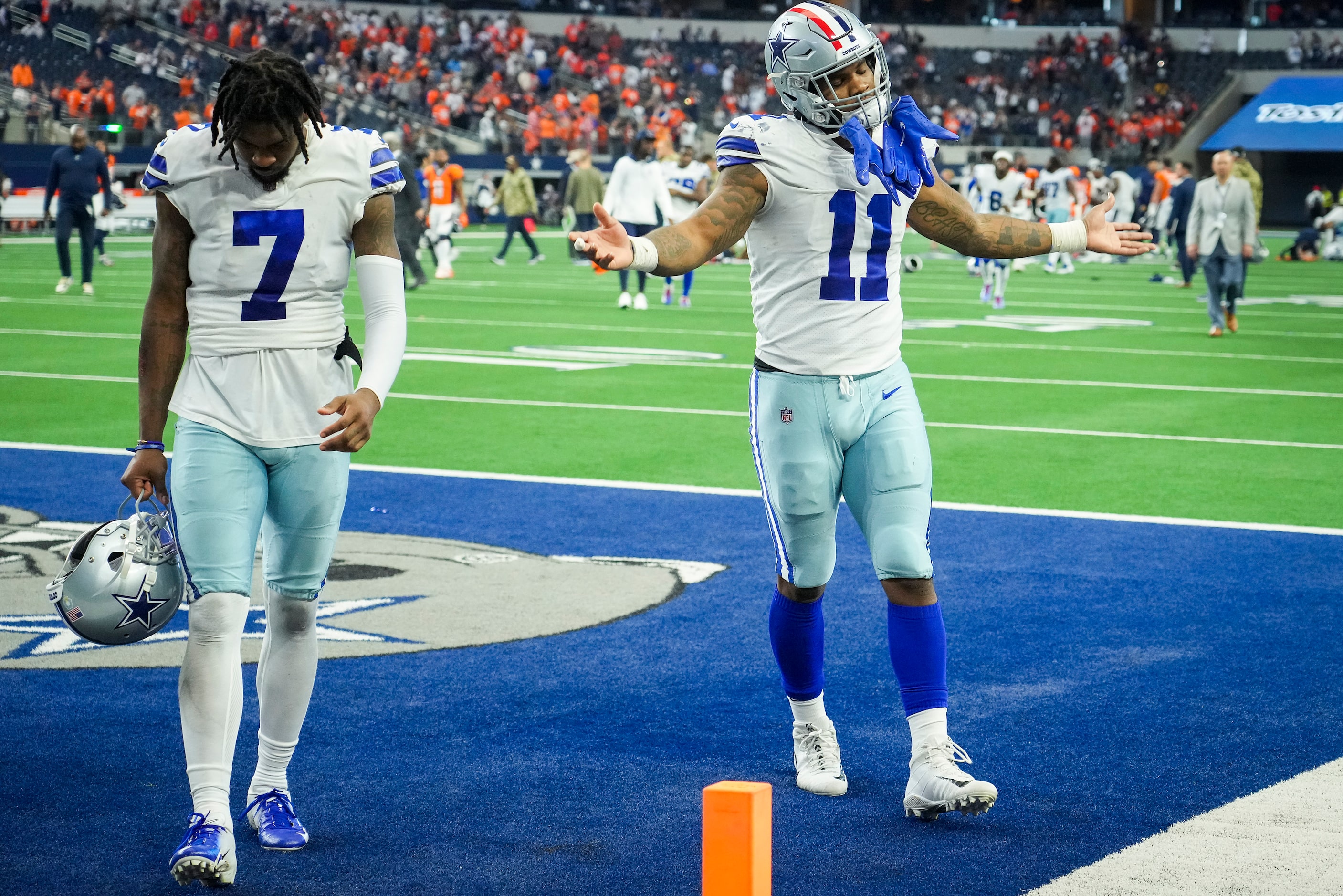 Dallas Cowboys Trevon Diggs (7) and outside linebacker Micah Parsons (11) leave the field...