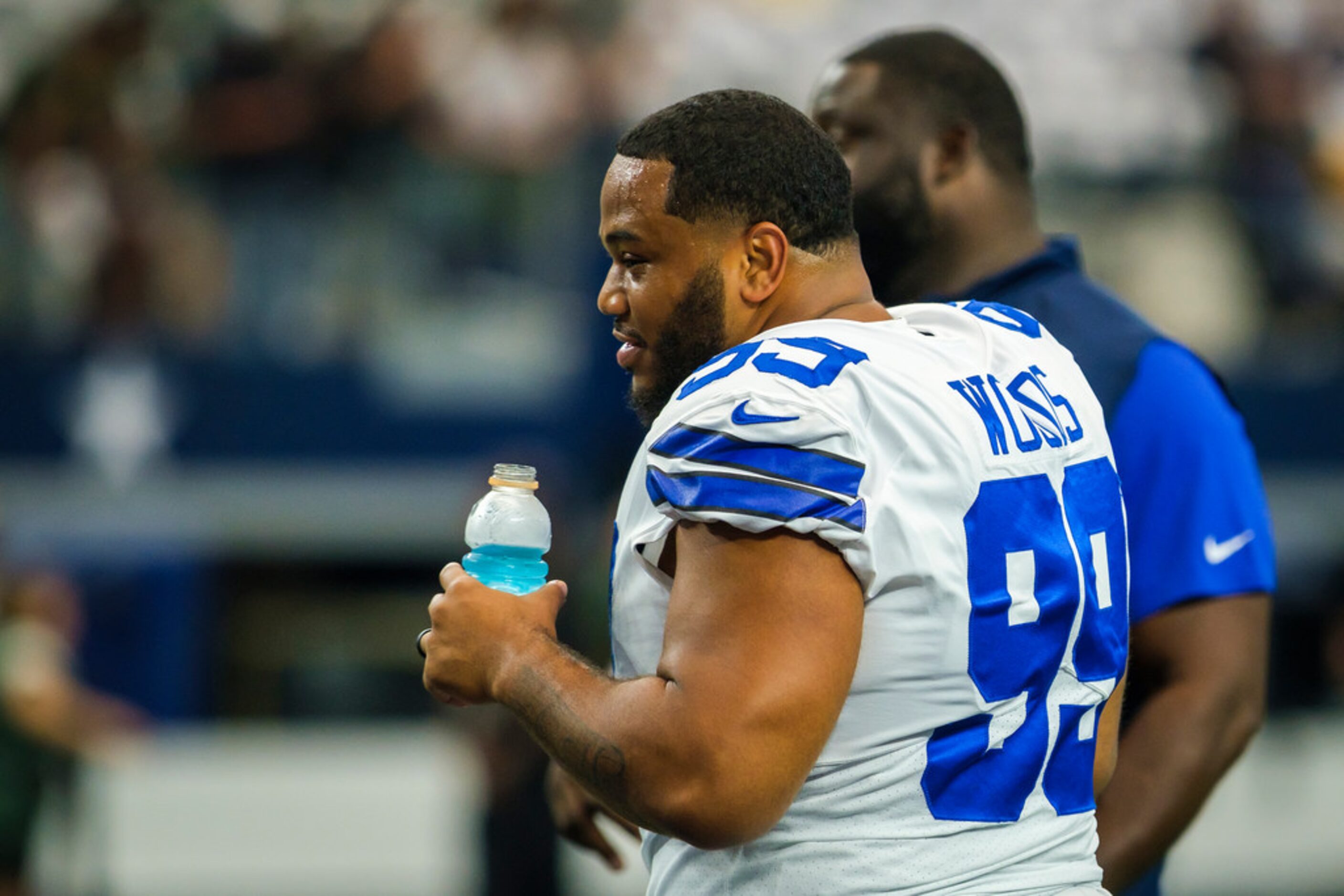 Dallas Cowboys defensive tackle Antwaun Woods watches teammates warmup before an NFL...