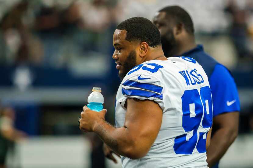 FILE - Dallas Cowboys defensive tackle Antwaun Woods watches teammates warmup before an NFL...