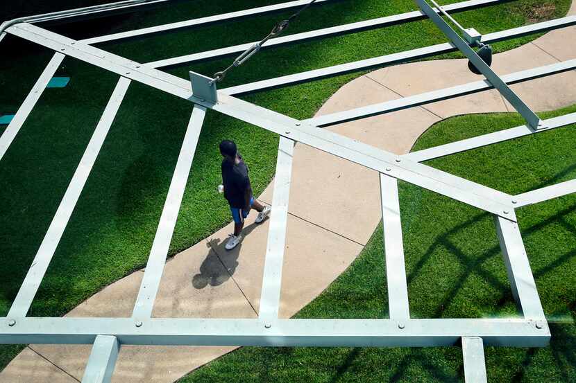 As temperatures soared to 107 degrees, a man walks through the Cancer Survivors Plaza in...