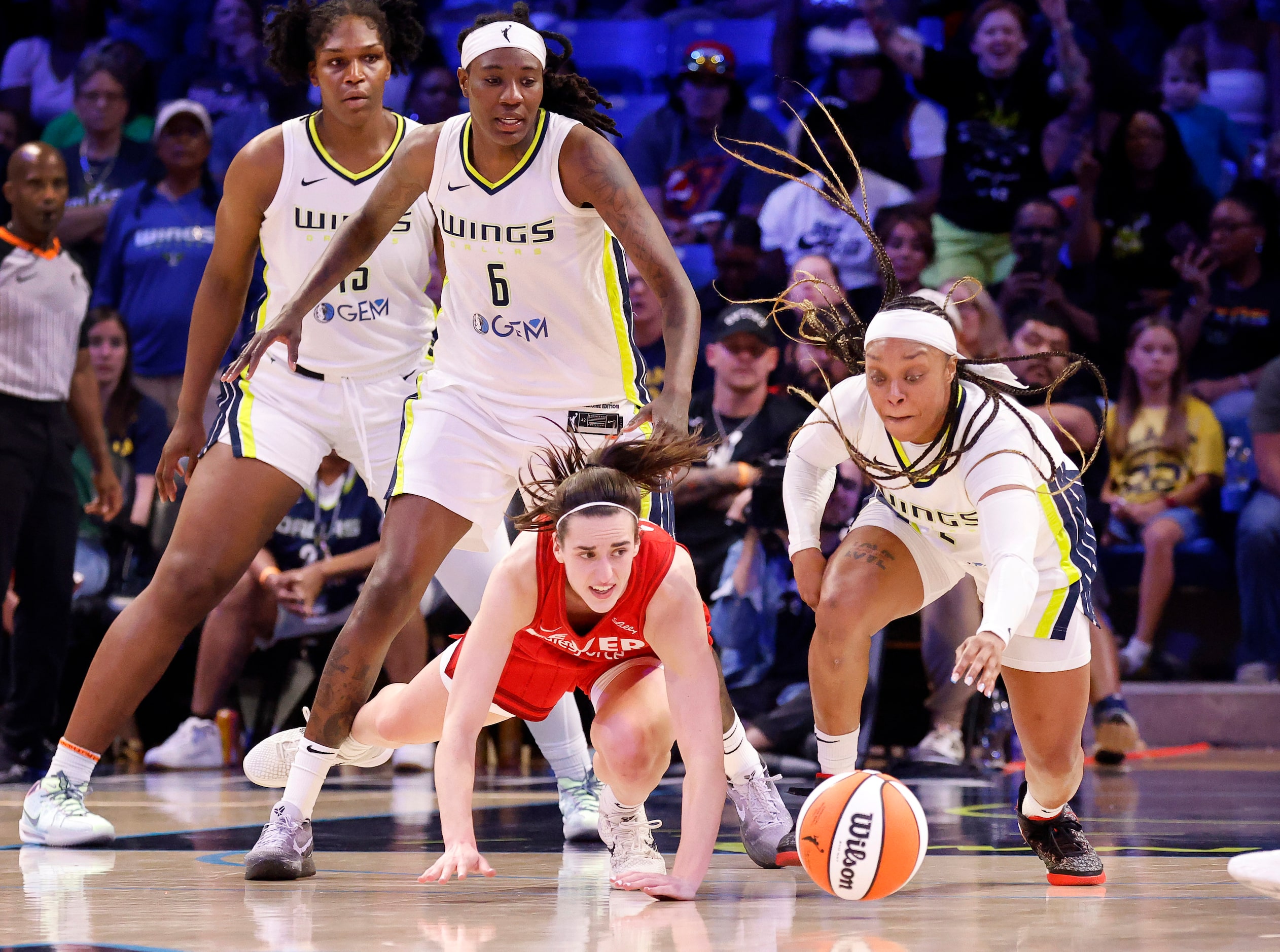 Indiana Fever guard Caitlin Clark (22) turns and reaches for the ball after Dallas Wings...