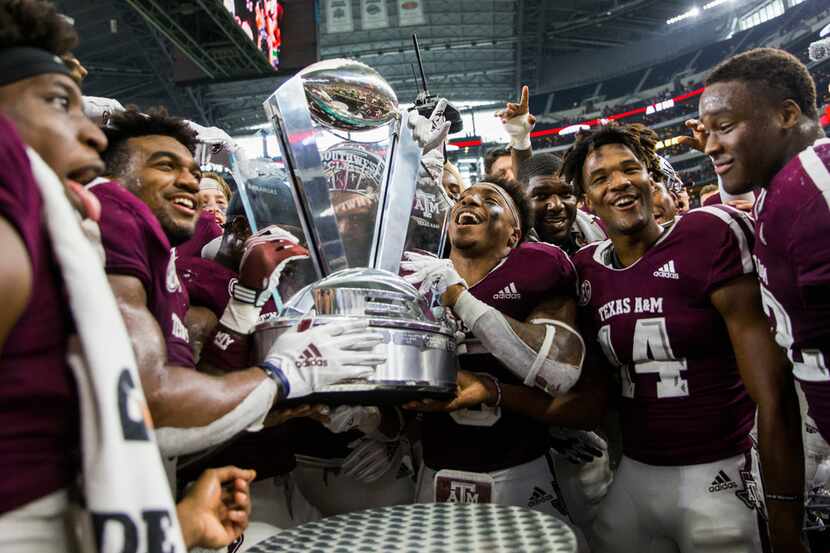 The Texas A&M Aggies accept the Southwest Classic trophy after a 24-17 win over Arkansas...