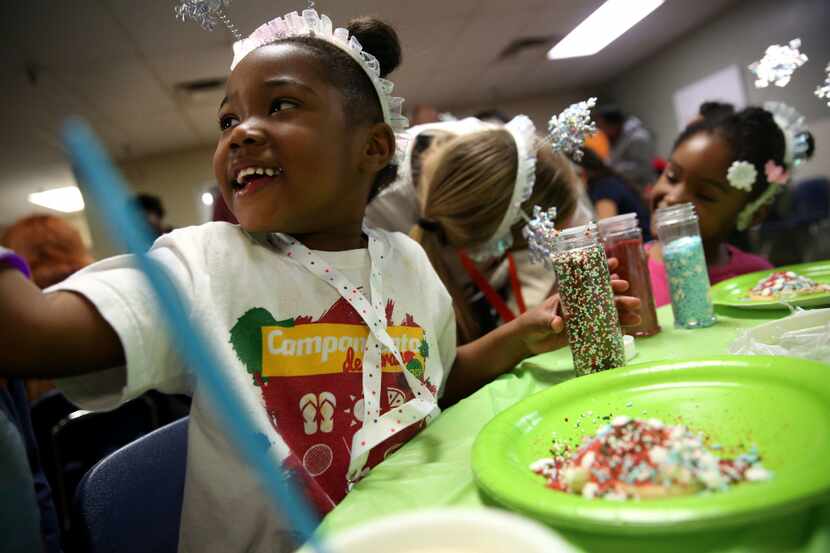 London Robinson, 5, decorates a sugar cookie during a birthday celebration hosted by The...