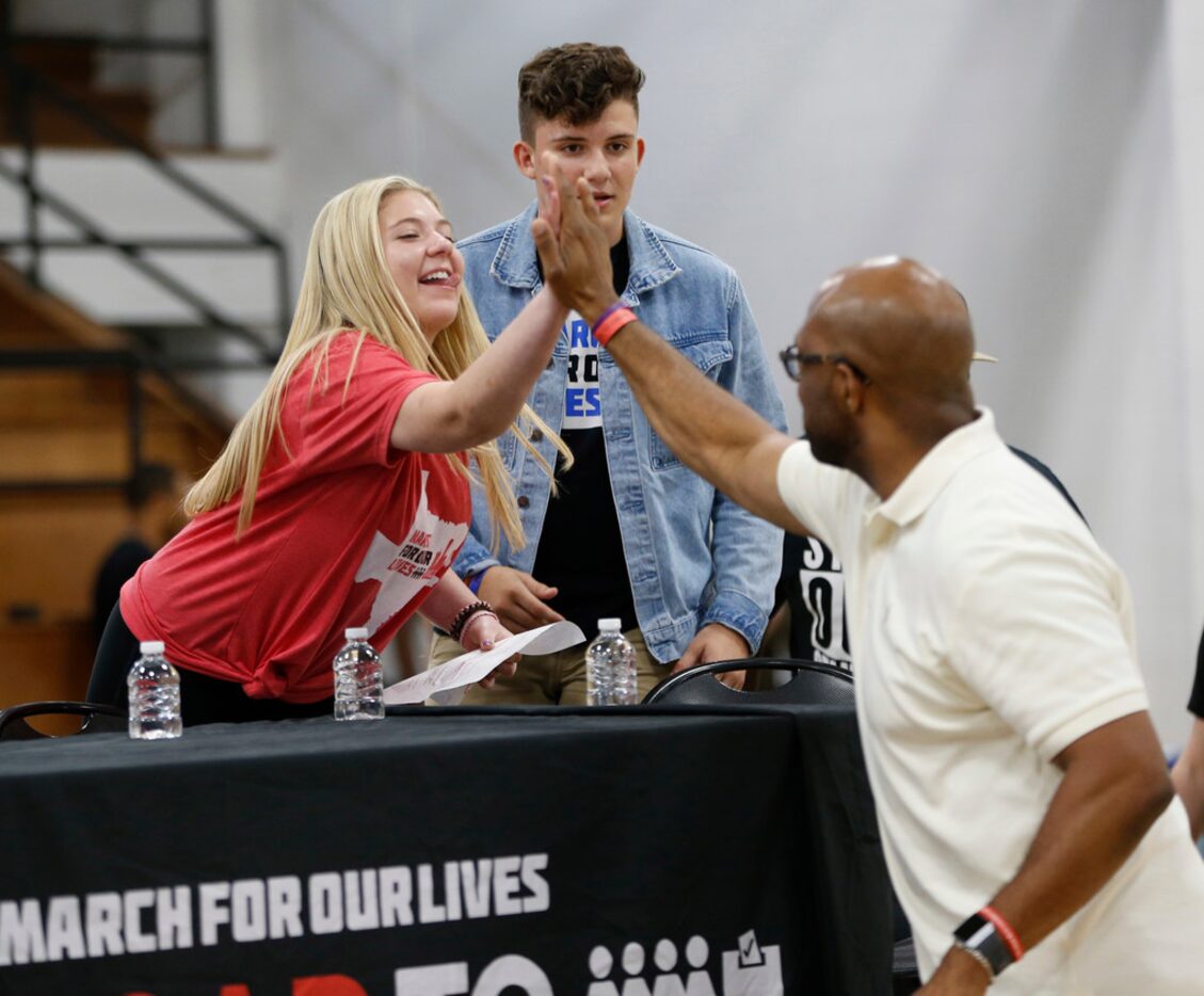 Jaclyn Corin (left) high-fived Michael Sorrell, president of Paul Quinn College, during a...