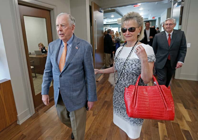T. Boone Pickens (left) and his wife Toni Brinker Pickens leave after a dedication ceremony...