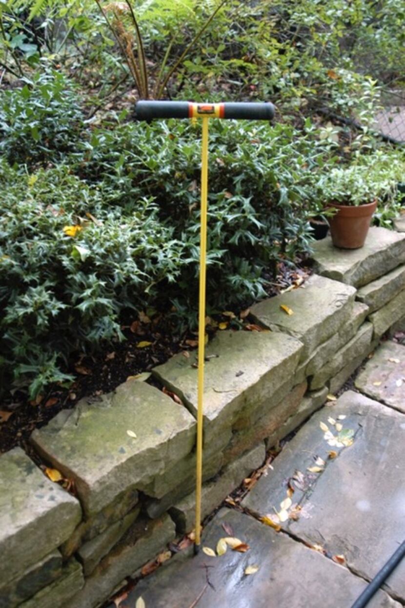 A pipe probe measures soil moisture.