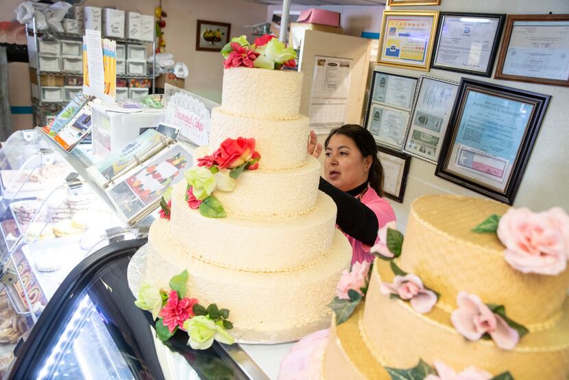 Naomi Vera Chavarria helps customers purchase a cake at Vera's Bakery Inc. in Dallas on Nov....