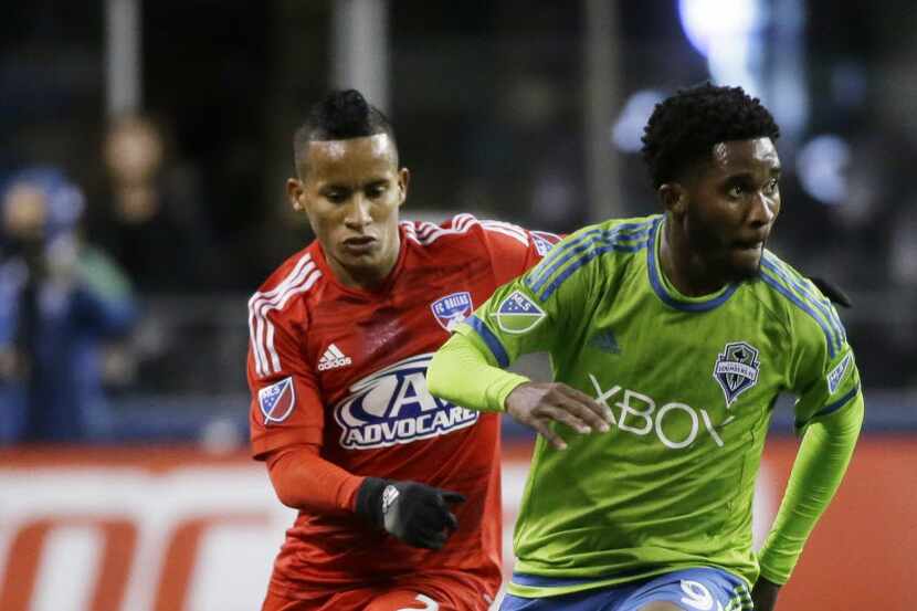 Seattle Sounders' Oniel Fisher, right, dribbles around FC Dallas' Michael Barrios, left, in...