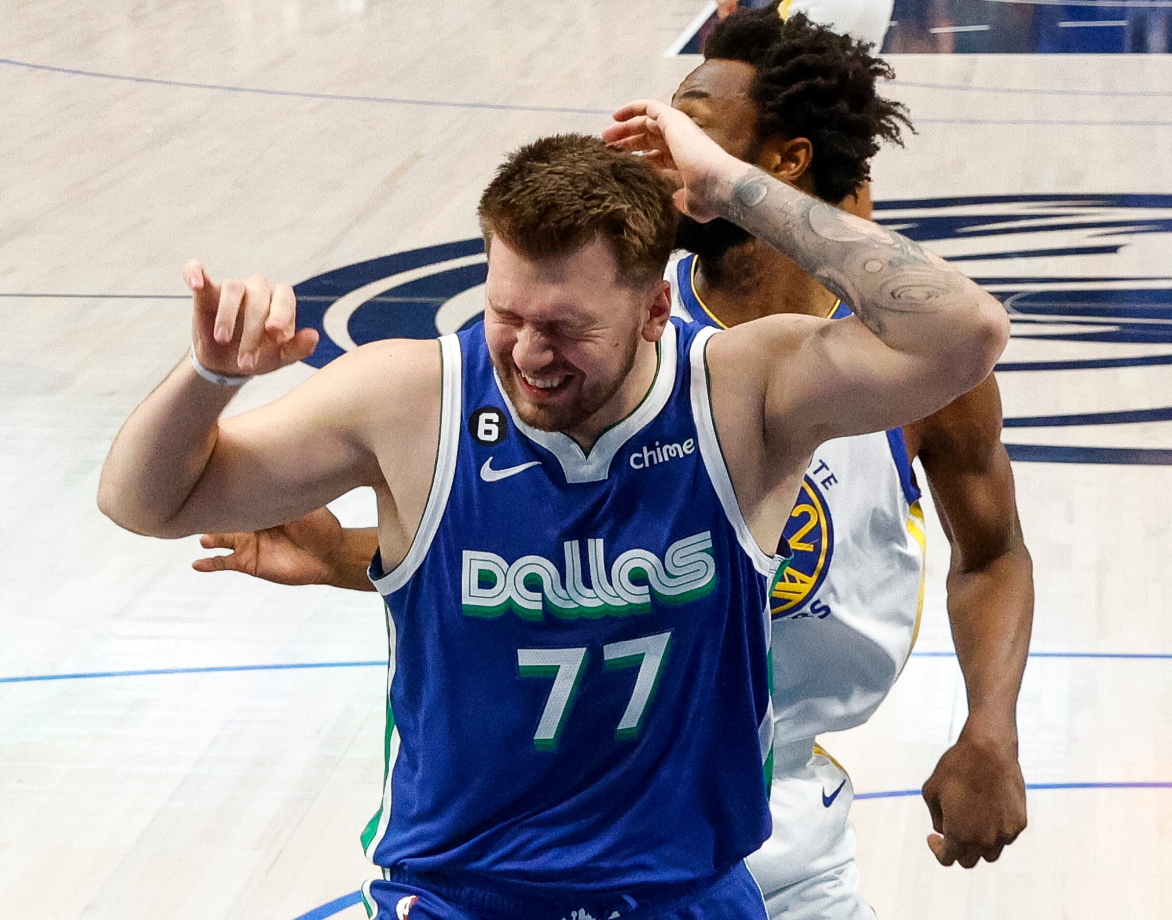 Dallas Mavericks guard Luka Doncic (77) reacts after being hit in the head by Golden State...