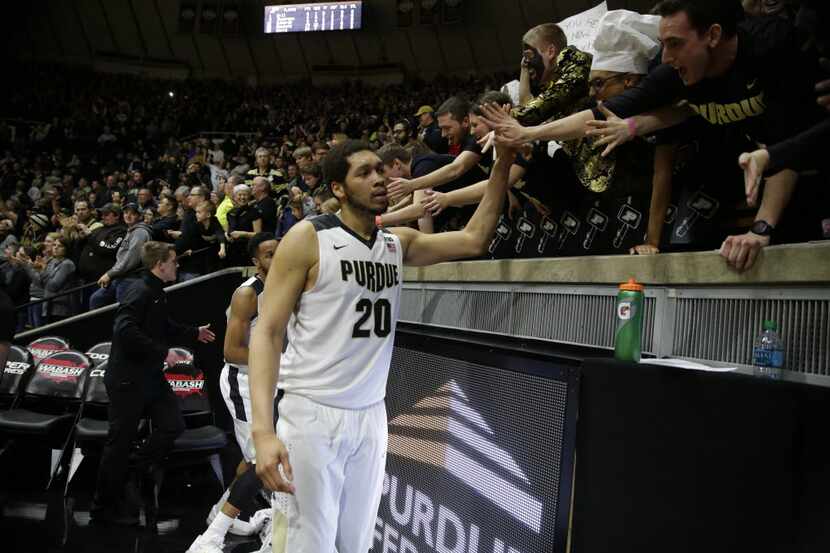 Purdue center A.J. Hammons (20) celebrates with fans following an NCAA college basketball...