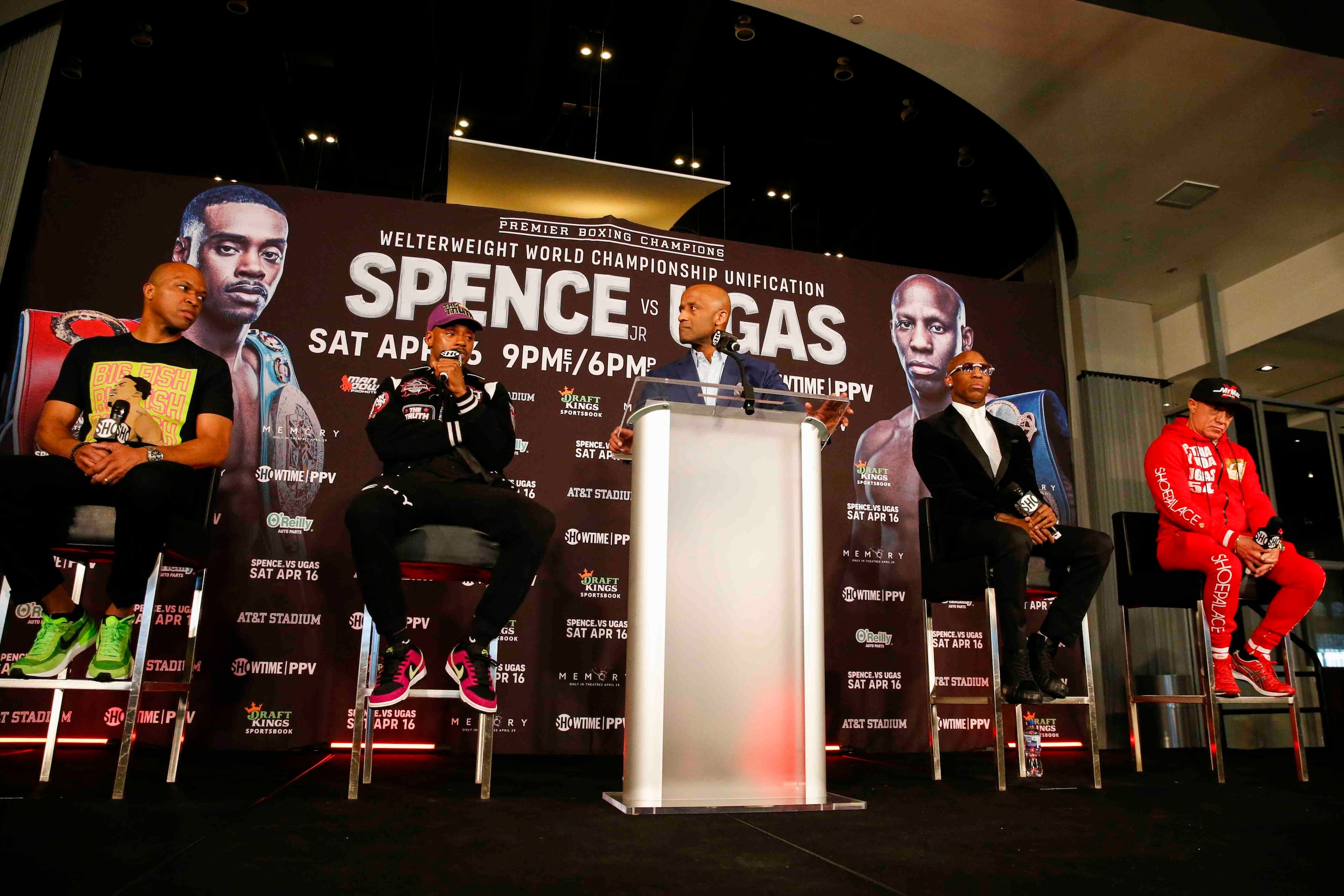 Errol Spence Jr., second from left, speaks as his coach Derek James, left, and Yordenis...