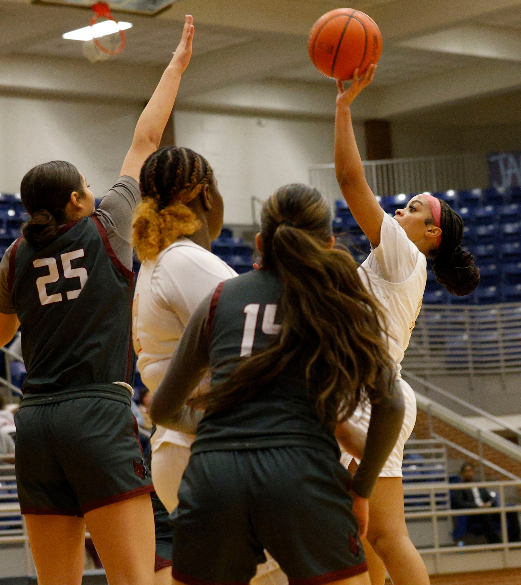 South Grand Prairie's Spirit Sheriff (1) shoots over Frisco Heritage's Ella Hooper (25) and...